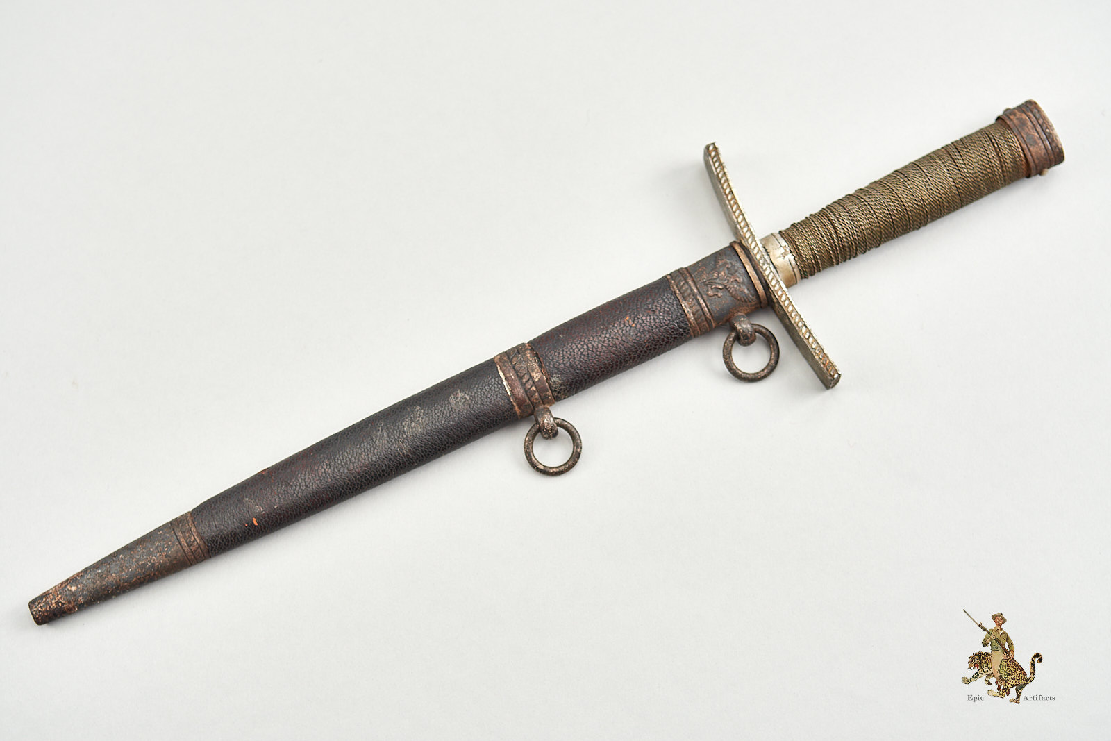 A dagger M 37 for Hitler Youth leaders, with hanger. Maker M7/36, E & F  Hörster, Solingen. Plated blade, the obverse side etched with the motto  Blut und Ehre! (Blood and Honour!). The reverse etched RZM and M7/36.  Silver-plated cross